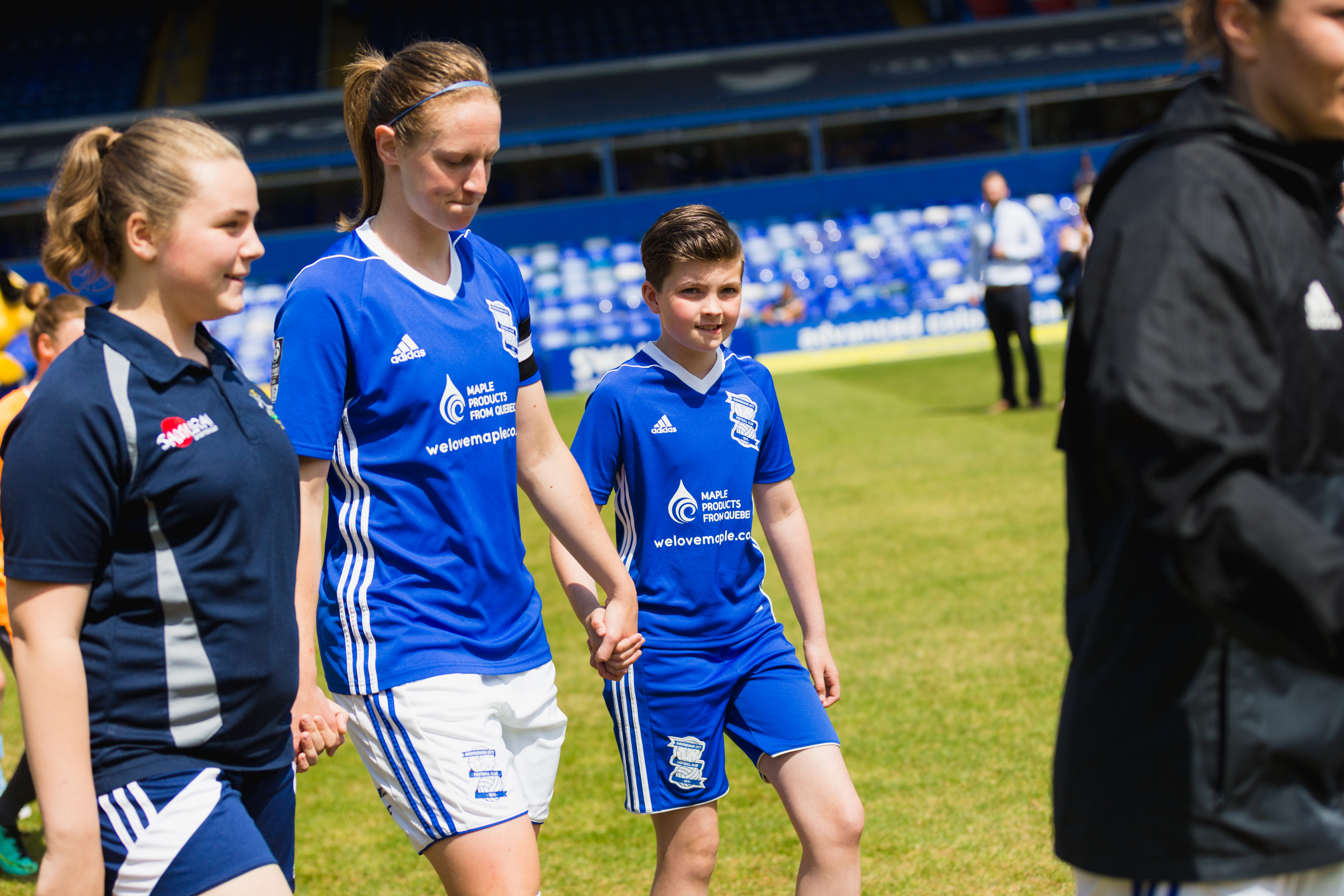 competition winner, Millie Jenkins-Caley, walking out with the Birmingham City Ladies FC players