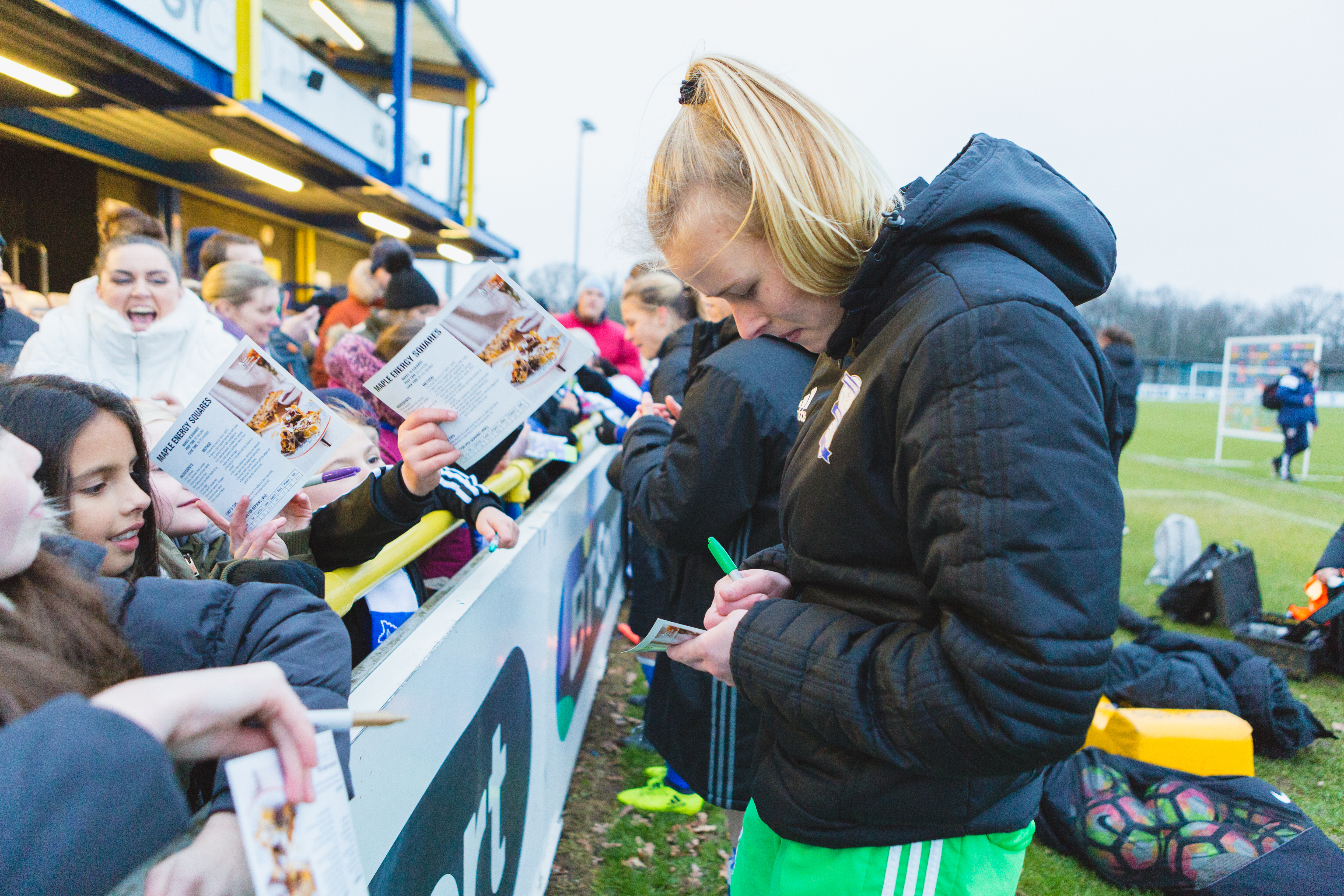 Birmingham City Ladies FC players signing autographs for young fans