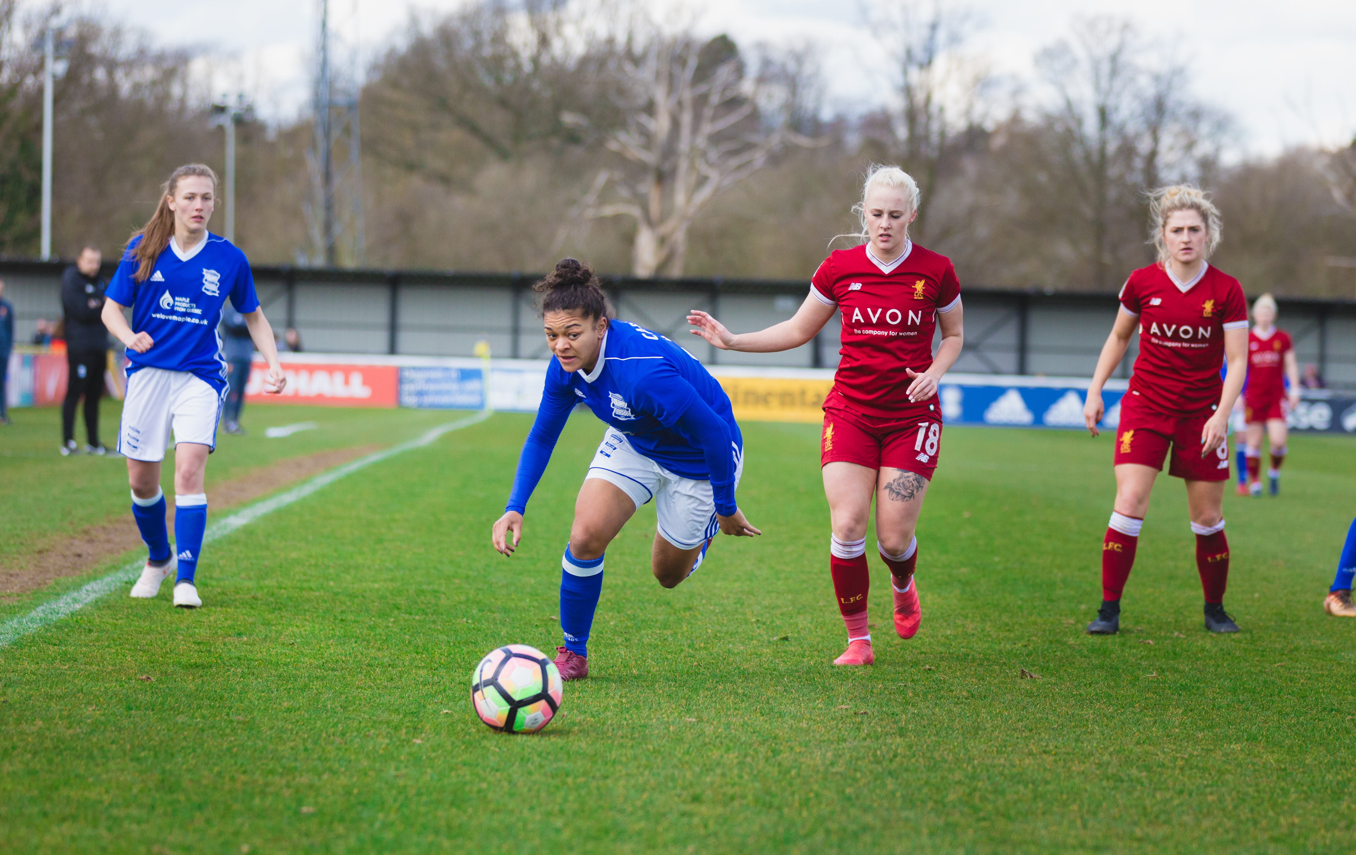 Birmingham City Ladies FC player beating opponents to the ball