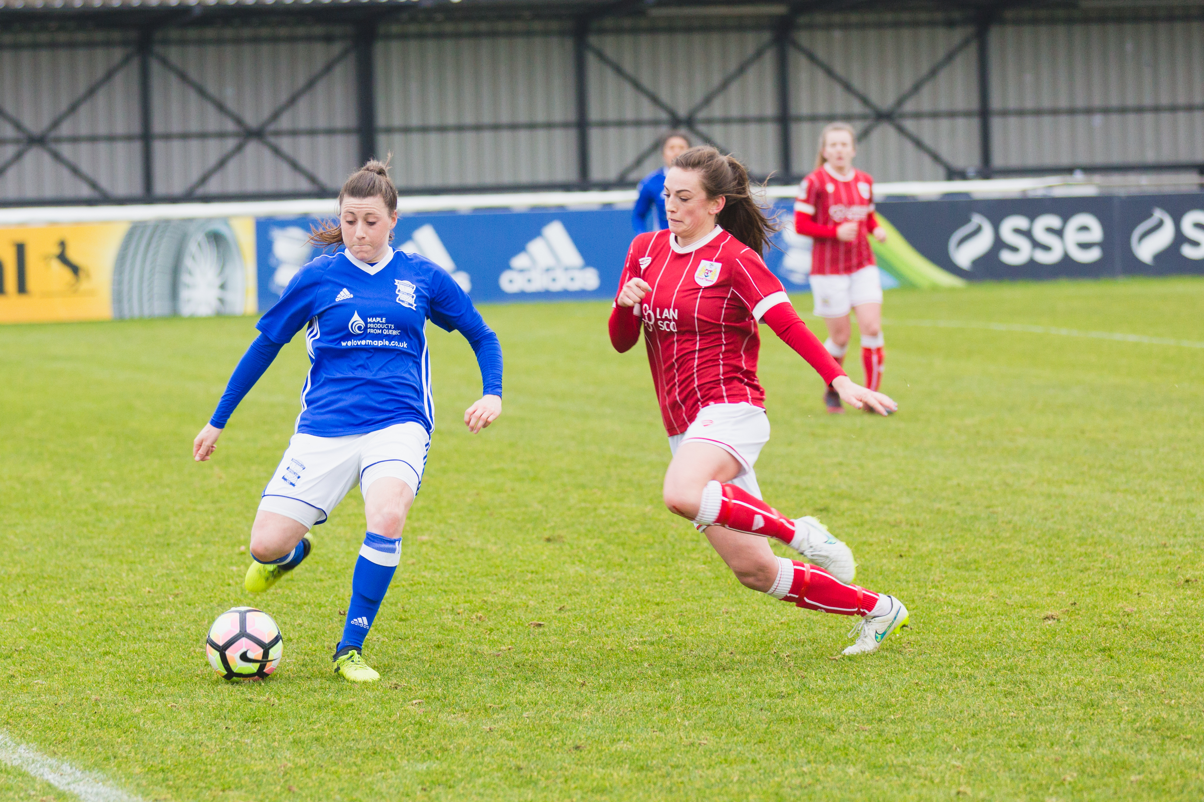 Birmingham City Ladies FC player kicking the ball