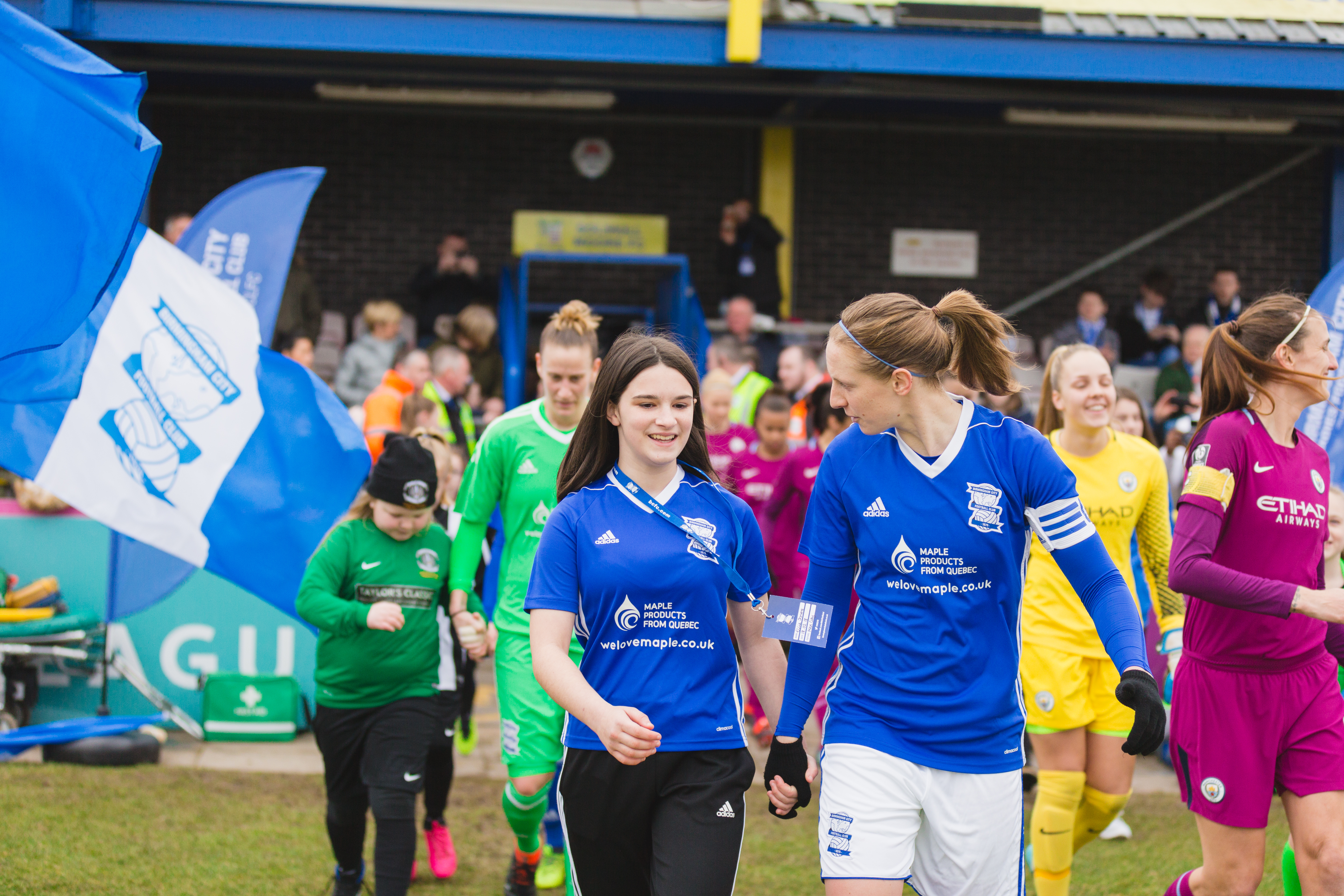 Competition winner, Ellie Jones, leads out Birmingham City Ladies FC 