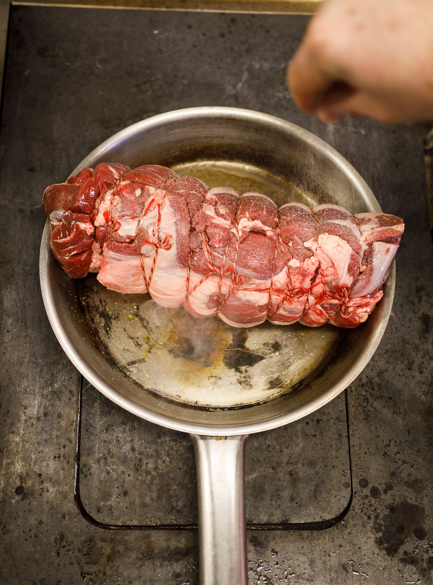 cooking the marinated joint of lamb with maple