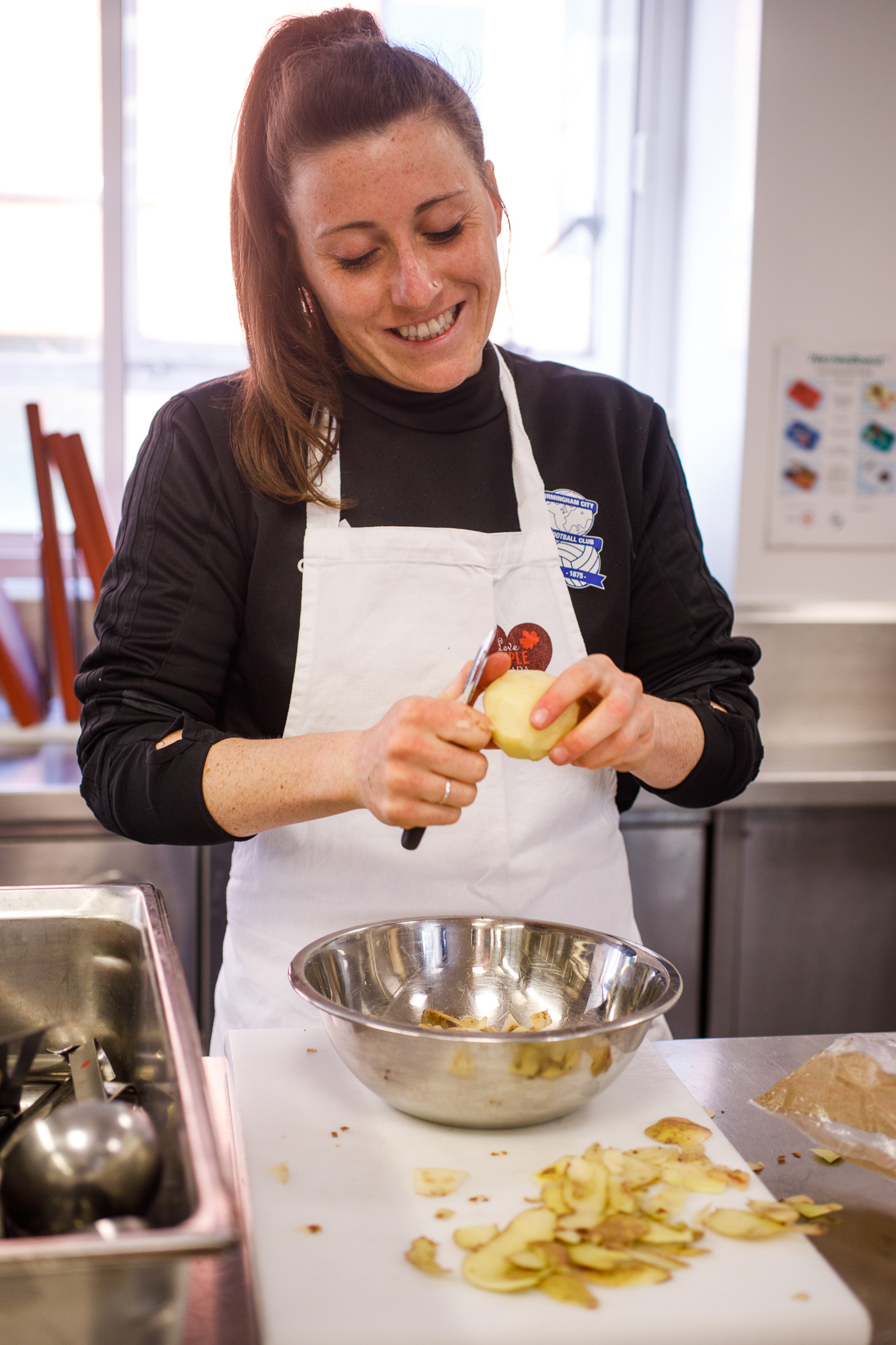 Birmingham City Ladies FC player peeling the potatoes 