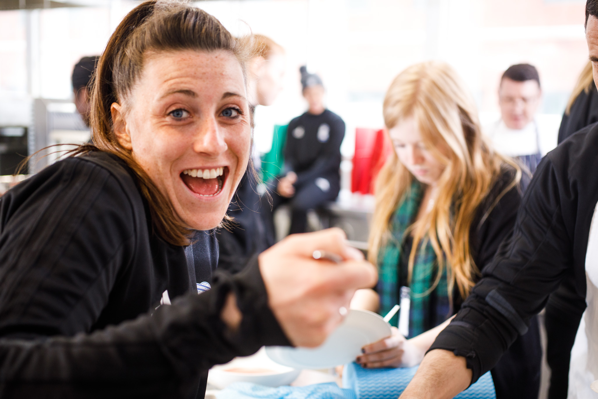 Birmingham City Ladies FC player taste testing the food