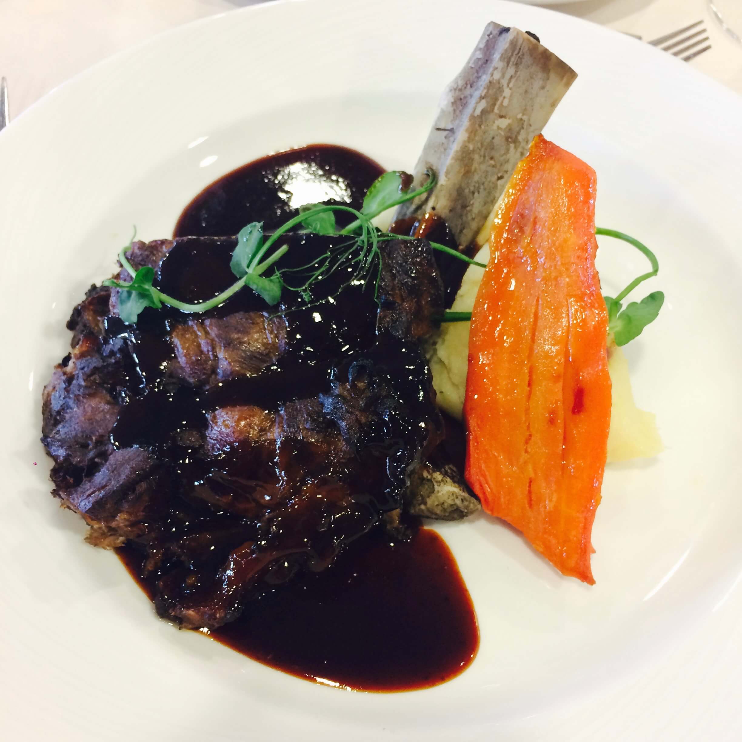 Maple glazed short rib of beef, horseradish mash, carrots, spinach, port reduction