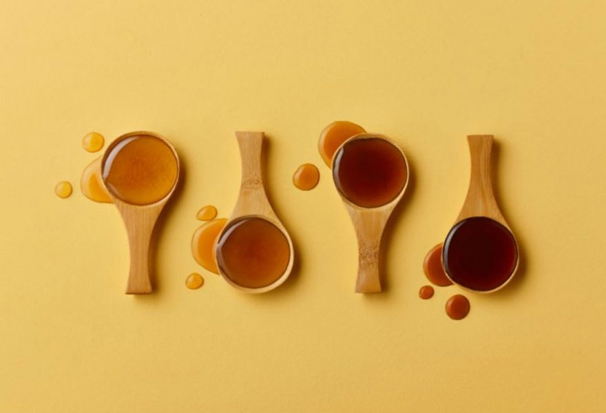 Spoons filled with maple syrup of new grades based on color and taste