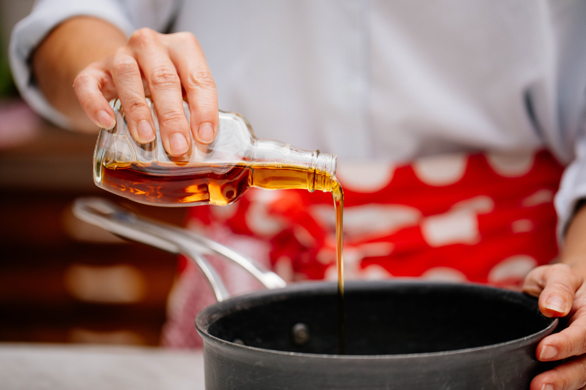 Pouring maple syrup into a pan
