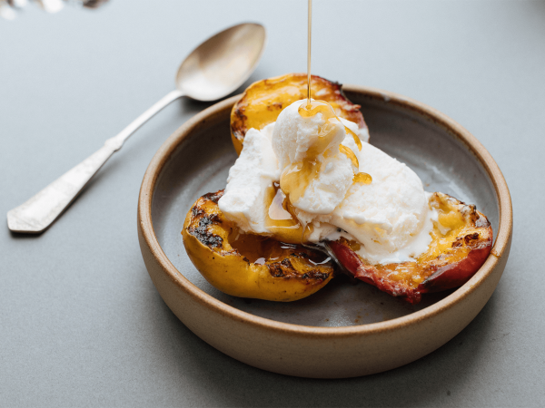 Griddled exotic fruits with maple and lime in a bowl