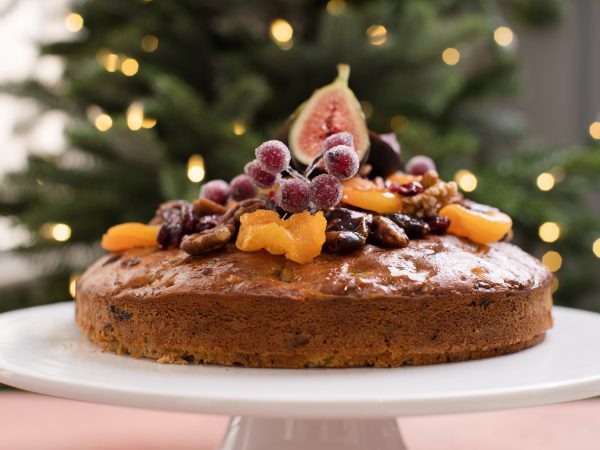 Christmas Maple Cake topped with fruit on plate